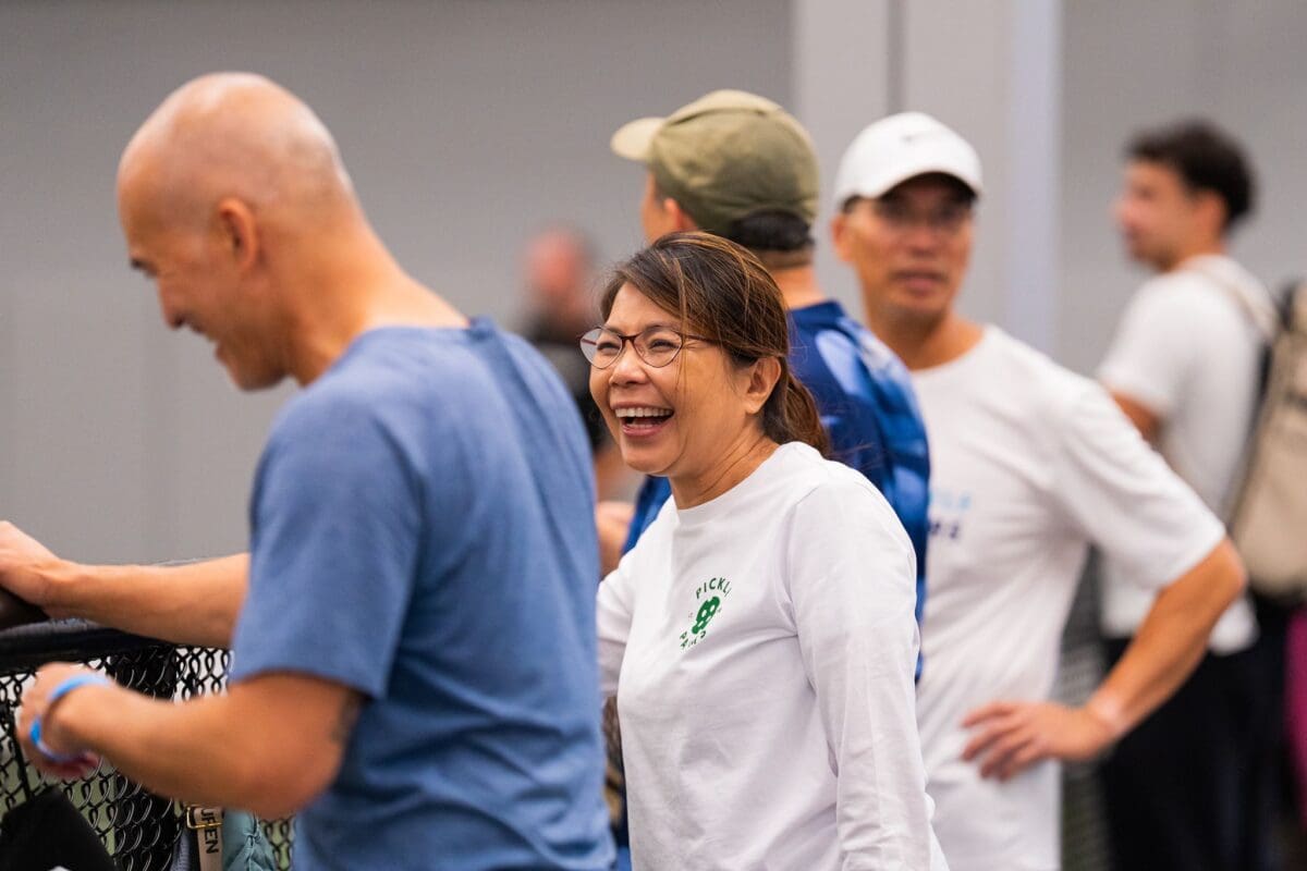 Over 50 pickleball players laughing