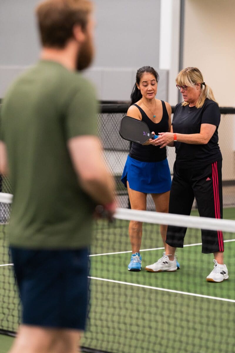 woman coach teaching beginner pickleball